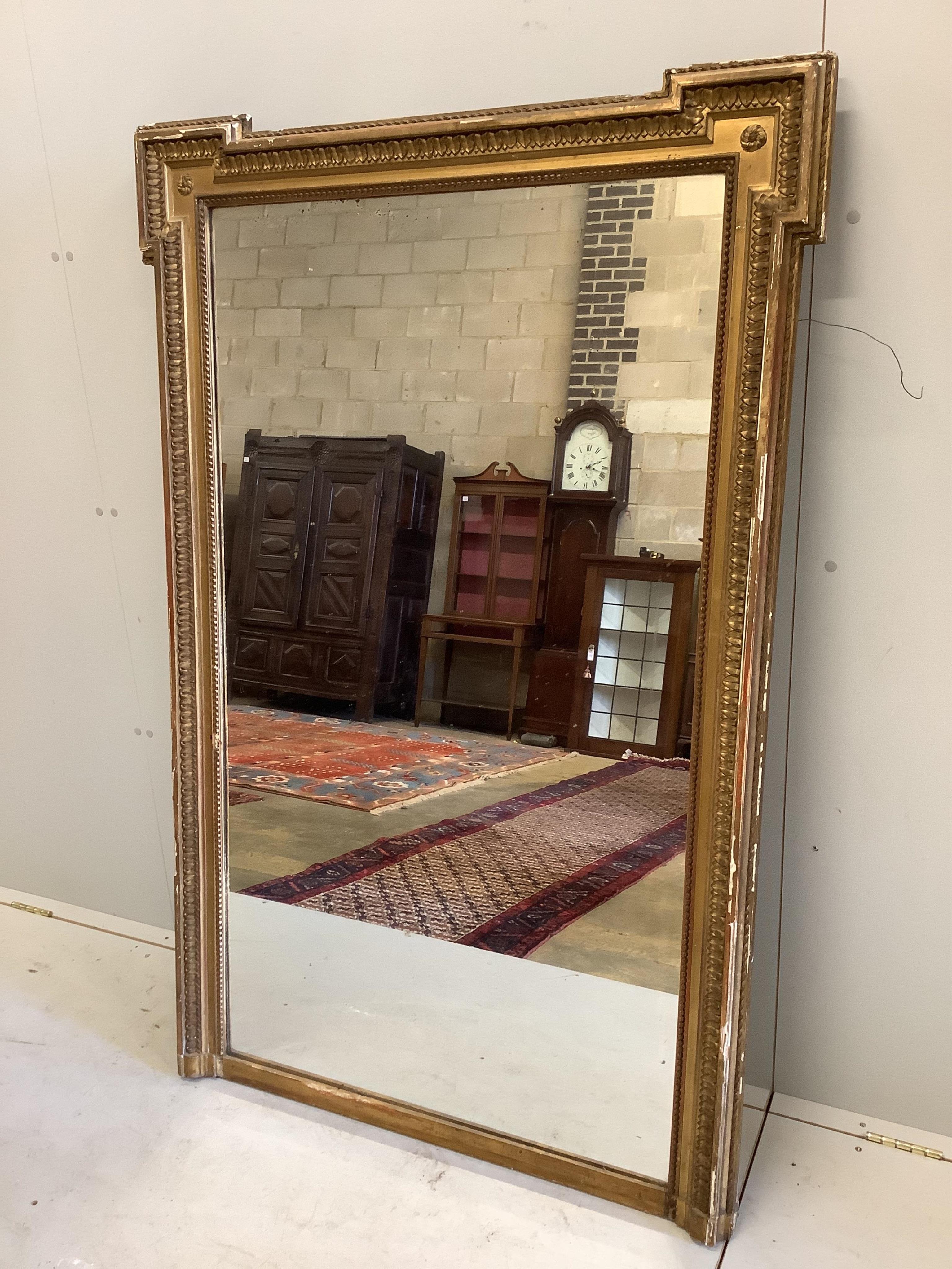 A late 19th century French gilt gesso wall mirror, width 100cm, height 153cm. Condition - extensive small losses and damages to the frame